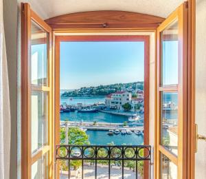 an open window with a view of a harbor at 4 bedrooms seafront Villa LAURUS with heated pool for up to 8 people in Sumartin