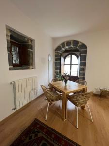 a dining room with a wooden table and chairs at Torre Ortiz de Zárate in Artómaña +7 photos