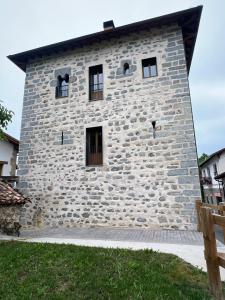 a stone building with windows on the side of it at Torre Ortiz de Zárate in Artómaña