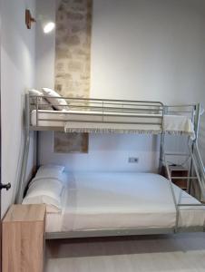two bunk beds in a room with white walls at Inma Enea in Armañanzas