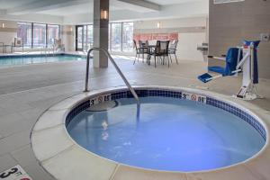 a hot tub in the middle of a swimming pool at TownePlace Suites by MarriottDetroit Canton in Canton