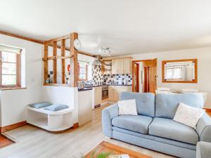 a living room with a couch and a kitchen at Horseshoe in Little Glenham