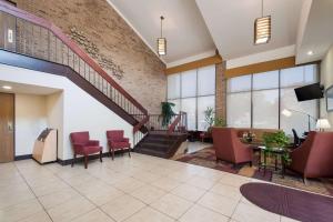 a lobby with chairs and a staircase in a building at Best Western Manassas in Manassas