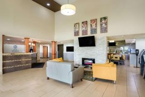 a lobby of a hospital with chairs and a fireplace at Best Western Waukesha Grand in Pewaukee