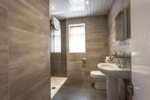 a bathroom with a toilet and a sink at The Glendower Hotel in Lytham St Annes +79 photos