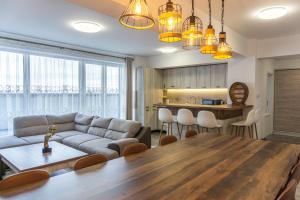 a living room with a couch and a table at KOA - Sunset Penthouse in Braşov