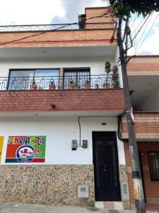 a building with a balcony with a sign on it at Casa tradicional - Cerca a la Zona Rosa in Envigado