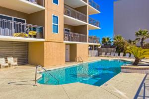 a swimming pool in front of a apartment building at Legacy 502 in Gulf Shores