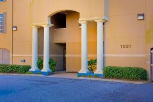 a building with four pillars on the side of it at Legacy 502 in Gulf Shores +21 photos