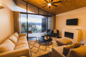 a living room with a couch and a tv at Kunama Townhouses in Jindabyne