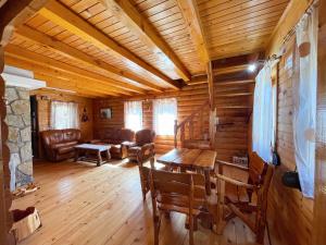 a living room with a table and chairs in a cabin at Lightning apartments in Žabljak