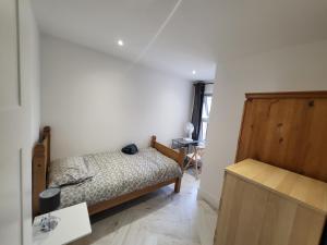 a small bedroom with a bed and a table at DaySpring White House - Dartford Kent in Kent