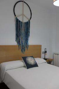 a bedroom with two beds and a chandelier at Apartament Ramon a Pobla in La Pobla de Segur