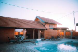 a house with a swimming pool in front of a house at Cartagena Villa & Spa in Brčko