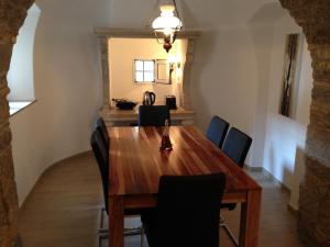 a dining room with a wooden table and chairs at Apartment Sand Beach in Opatija