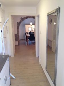 a hallway leading into a dining room with a mirror at Apartment Sand Beach in Opatija