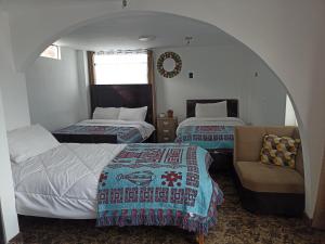 Rúm í herbergi á Hostal Killaly Inn Cusco +12 myndir
