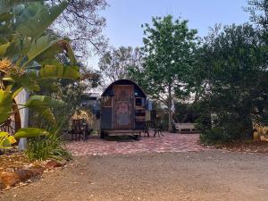 una casa con una puerta en un patio de ladrillo en Gypsy Van Tiny House with Unique Outdoor Bathroom, WIFI & Firepit, en Coodanup