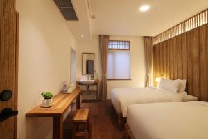Ένα ή περισσότερα κρεβάτια σε δωμάτιο στο Hantang Inn Hostel Xi'an
