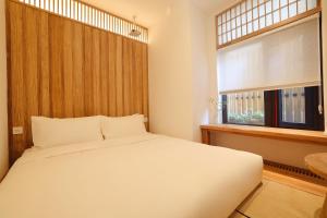 Ένα ή περισσότερα κρεβάτια σε δωμάτιο στο Hantang Inn Hostel Xi'an
