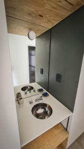 a bathroom with a sink in a room at Casa D, moderna de 2 habitaciones con jardín en barrio privado in San Salvador de Jujuy