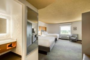 a hotel room with two beds and a mirror at Holiday Inn Mobile Downtown Historic District, an IHG Hotel in Mobile