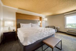 a hotel room with a large bed and a window at Holiday Inn Mobile Downtown Historic District, an IHG Hotel in Mobile