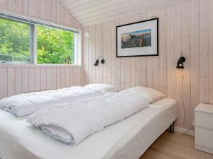 a bedroom with two beds with white sheets at 6 person holiday home in Oksbøl-By Traum in Oksbøl