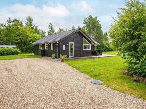 a small cabin with a gravel driveway at 6 person holiday home in Oksbøl-By Traum in Oksbøl