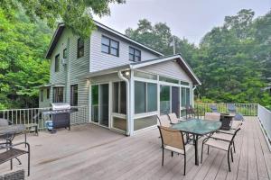 a large deck with a grill and a house at Roamer's Respite - A Prime Location with Scenic Views For Your Ultimate Retreat in Sylva