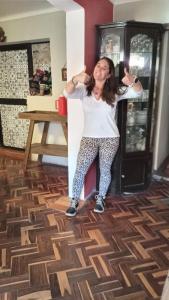a woman standing in a room with her arms in the air at Casa Salkantay Cusco in Cusco