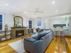 a living room with a couch and a fireplace at The Buoys in Blairgowrie +13 photos