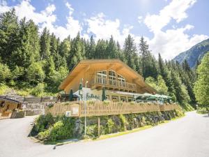 a large wooden house on a mountain at Pretty Holiday Home in Hollersbach im Pinzgau with Garden in Hollersbach im Pinzgau