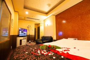 a hotel room with a bed with flowers on it at Restay lagoon in Tokyo