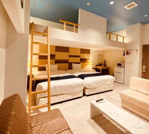 a bedroom with two bunk beds and a couch at Phoenix Park Hotel in Nago