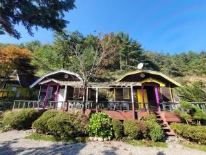 a house with a colorful front porch at White House Over Hill in Yangyang