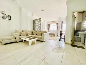 a living room with a couch and a table at Marilyn Studio with Sea View Wi Fi in Hurghada