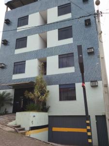 a building with a blue and white facade at Hotel Mundial in Itabuna