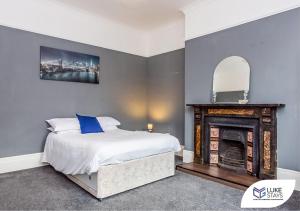 a bedroom with a bed and a fireplace at Luke Stays - Brandling Street in Monkwearmouth