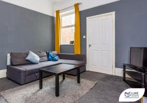 a living room with a couch and a coffee table at Luke Stays - Brandling Street in Monkwearmouth