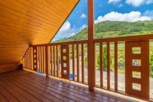 a wooden balcony with a view of a mountain at レジーナ石垣　ログテリアⅠ in Hirakubo