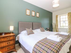 a bedroom with two beds and a wooden dresser at South Stables - House Of Dun in Montrose +21 photos