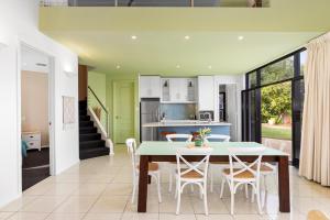 a kitchen and dining room with a table and chairs at Merlot Verdelho Townhouses in Penola