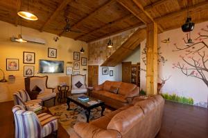 a living room with a couch and chairs and a table at Seclude Nahan, Bantony Cottage in Nāhan