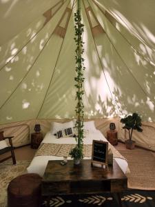 a bedroom in a tent with a bed and a table at Grotto Getaway in Miller Lake