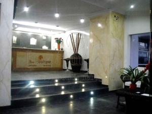 a lobby of a restaurant with lights on the stairs at Hotel Boutique Embajada de la Feria in Bogotá