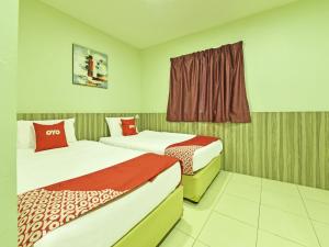 Voodi või voodid majutusasutuse Super OYO Capital O 90545 Ho Hotel toas