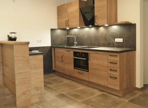 a kitchen with wooden cabinets and a sink at Haus Sonnengruß in Salem
