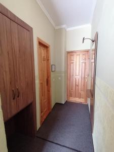 a hallway with two wooden doors in a room at Girska Tysa Health Resort in Kvasy