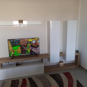 a living room with a flat screen tv on a wall at ADRIANA SEAHOUSE in Balestrate